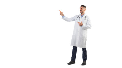 A man doctor is standing against a plain white background while pointing to the side and smiling....