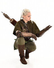 full length portrait of blonde female model wearing green fantasy elf warrior halloween costume...