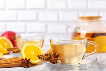 Fragrant hot tea with cinnamon stick and anise on a textured wooden background. A cup of hot tea...