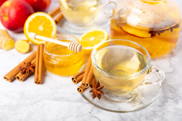 Fragrant hot tea with cinnamon stick and anise on a textured wooden background. A cup of hot tea...