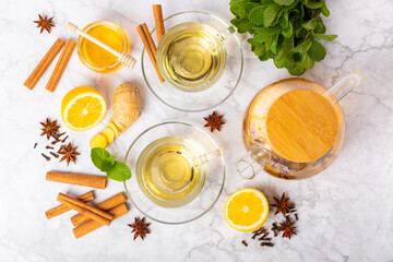 Fragrant hot tea with cinnamon stick and anise on a textured wooden background. A cup of hot tea...