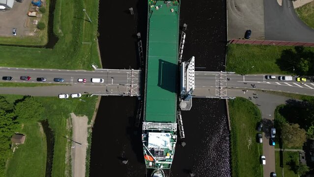 Aerial video over a river in Appingedam  Netherlands on passing cargo ships