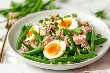 Fresh Tuna and Egg Salad with Green Beans. A delicious and healthy salad made with fresh tuna, soft-boiled eggs, and green beans, garnished with herbs.