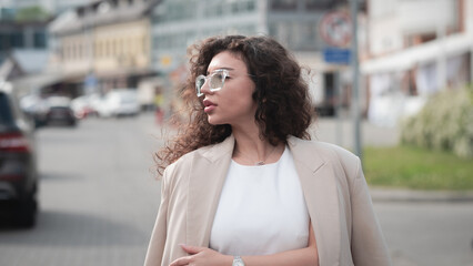 Stylish beautiful woman portrait in summer on city street