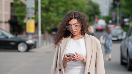 Stylish beautiful woman portrait in summer on city street