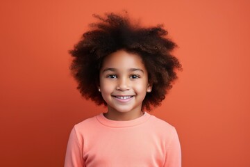Coral background Happy black american african child Portrait of young beautiful kid Isolated on Background ethnic diversity equality acceptance concept with copyspace 