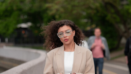 Fototapeta premium Stylish beautiful woman portrait in summer on city street