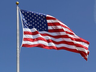 American flag flying against blue sky.
