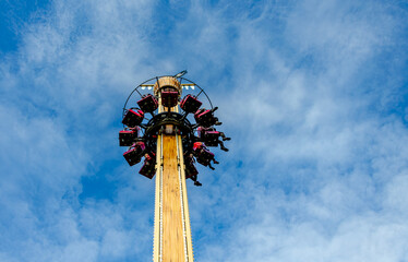 The attraction is a free fall tower against the sky.