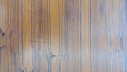 A wooden surface with a pattern of lines and grooves