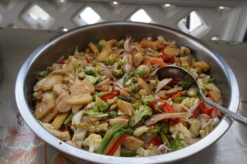 Stir-fried vegetables. Mixed vegetables of carrot, broccoli, mushroom,  capsicum, and chicken meat.