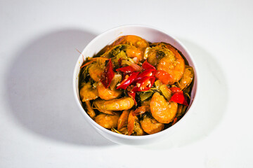 shrimp dishes in butter sauce with a white porcelain bowl