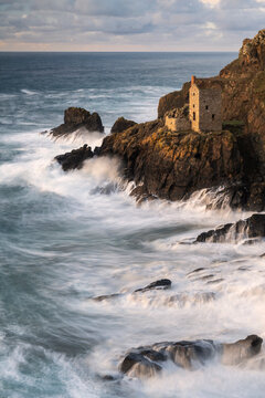 Crown's Engine Houses at Botallack during high tide at sunset. West Cornwall, UK. November 2020.  

