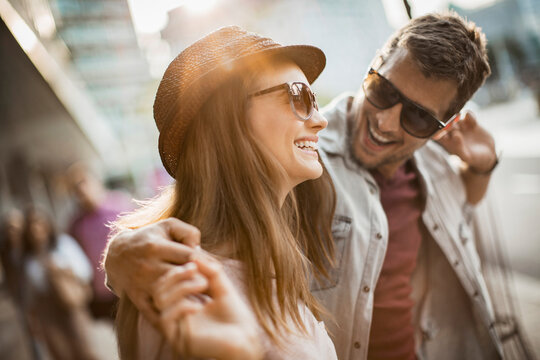 Happy couple shopping together in the city