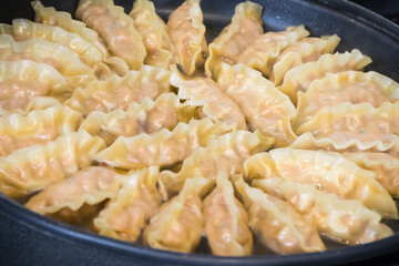 Fried dumplings on frying pan. Traditional food