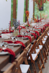 wedding holiday banquet in the open air. covered, served tables in the yard, garden in nature. wooden tent covered with fabric, wedding banquet