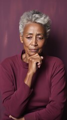 Maroon background sad black American independent powerful Woman. Portrait of older mid-aged person beautiful bad mood expression girl Isolated