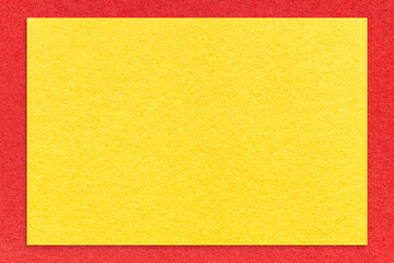 Texture of craft yellow color paper background with red border, macro. Structure of vintage kraft cardboard.