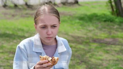 girl with blond hair, 12 years old, eats a delicious bun, no diet, cinnamon bun
