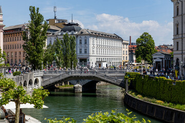Center of Ljubjiana. Buildings, architecture, castle in the capital of Slovenia. The famous bridges and the traditional symbol of the dragon. Boat on the river. City with attention to detail.