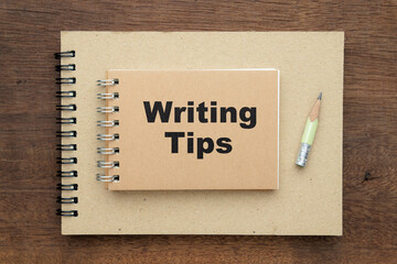 Writing Tips small notebook placed over the big one to create, creative writing plan