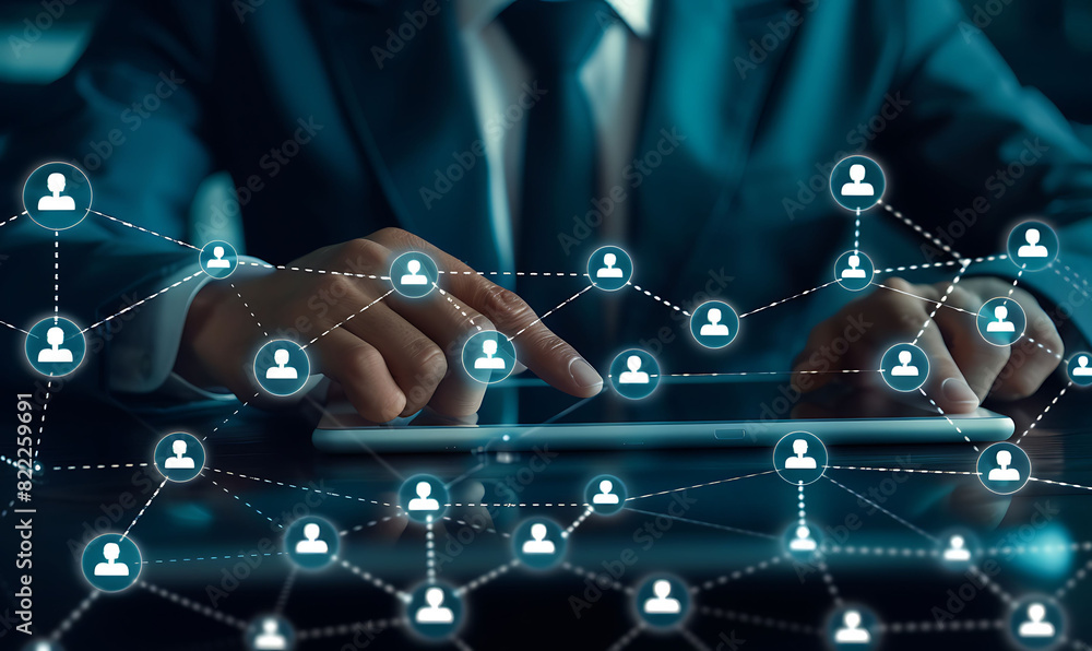 Leinwandbilder A businessman using a digital tablet to manage customer relationships, featuring a virtual network overlay of interconnected icons, representing CRM and global communication