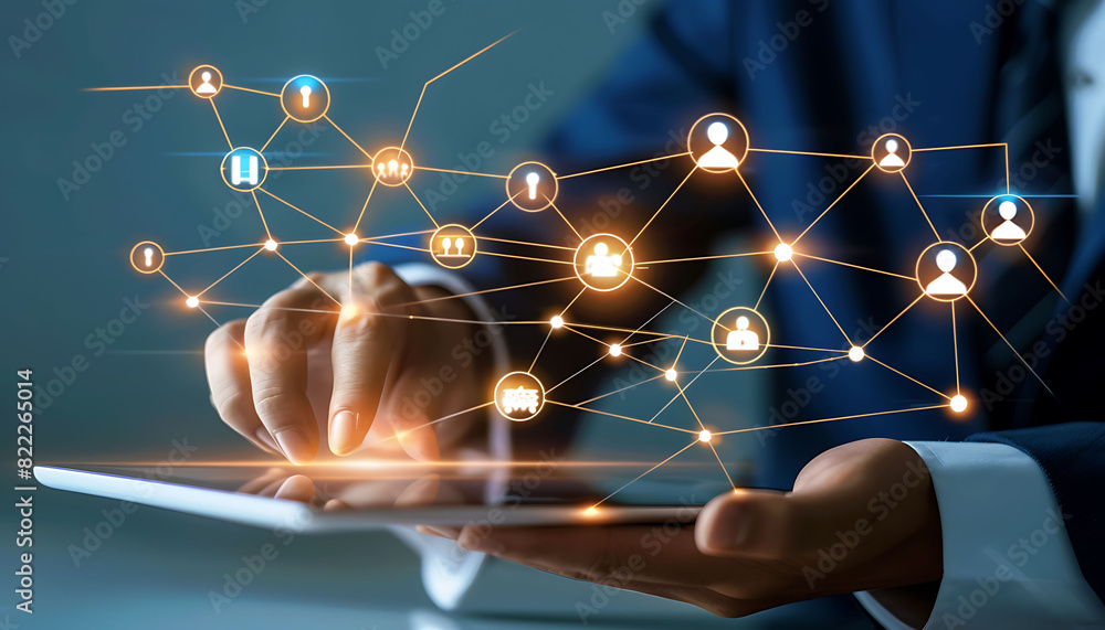 Leinwandbilder A businessman using a digital tablet to engage with a virtual network of customer and HR icons, demonstrating advanced technology for CRM and recruitment