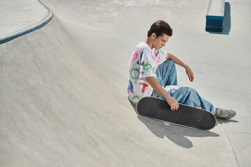 A young man deep in concentration as he sits on his skateboard gliding through a vibrant skate park...