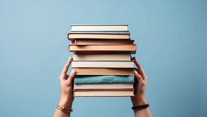 Hand holding stack of books