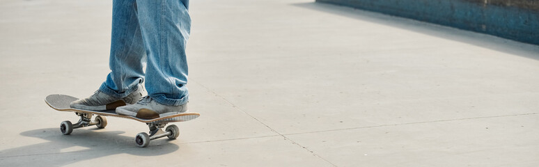 A young skater boy maneuvers his skateboard deftly on a bustling city sidewalk on a sunny summer...