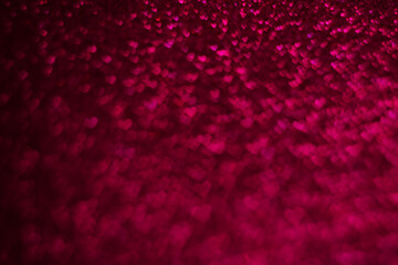 A close up of a red background with many small heart shapes scattered throughout