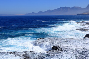 Playa de Cofete, Jandia, Fuerteventura, Canary Islands, Spain: Amazing beach behind the with stormy Atlantic Ocean, Volcanic hills in the background