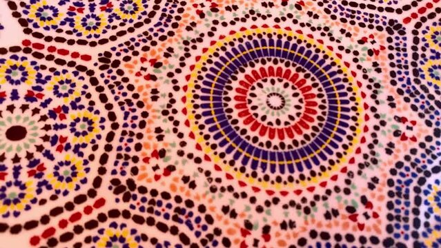 full frame shot of Moroccan traditional mosaic called Zelige with abstract effect. Traditional Moroccan tile floor. Abstract geometric design background footage. Rotating.

