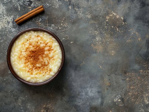 Top view of Portuguese arroz doce with cinnamon, using the rule of thirds, with ample copy space, sweet and creamy, high-quality image