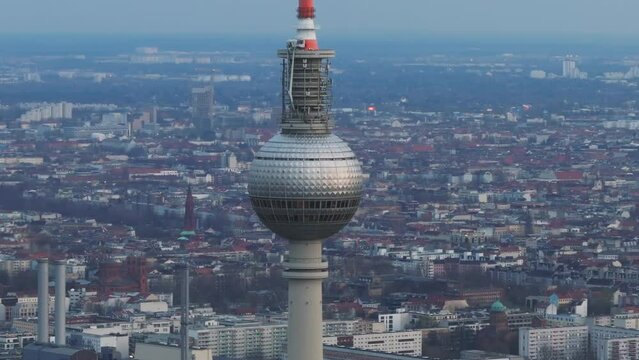 Drone footage of Berlin's TV tower in Alexanderplatz with cityscape in the background. Aerial view of iconic structure in Germany's capital city