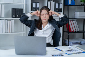 Stress at work, sitting with a stressed face, standing and stretching the body of an office woman.