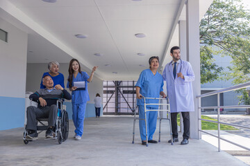 doctor or nurse helping Senior Woman to walk at nursing home with walker. Doctor or nurse helping old elderly Woman grandfather to walk using walker equipment