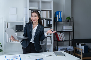The Asian female business professional displayed a cheerful expression in her office.