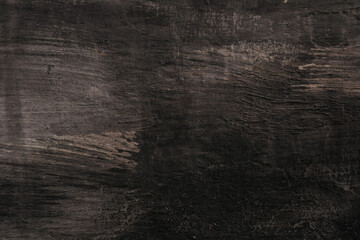 A dark wood grain background with a few brush strokes