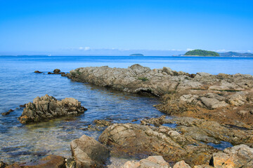 ゴツゴツした岩の潮溜りの透き通った青い海