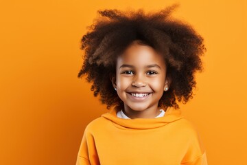 Orange background Happy black american african child Portrait of young beautiful kid Isolated on Background ethnic diversity equality acceptance 