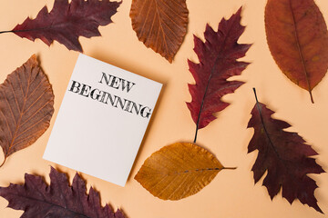 A white piece of paper with the words New Beginning written on it is placed on
