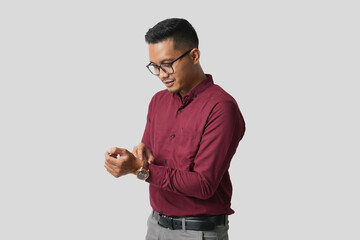 A handsome young Asian man in a suit wearing glasses and making various facial expressions isolated on a white background