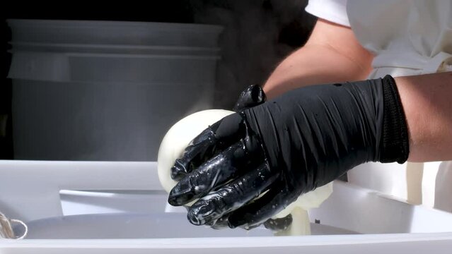 Caciocavallo how to prepare kachakovala cheese step by step in a home craft cheese factory, female hands in black latex gloves prepare a delicious product Italy Switzerland