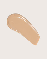 Makeup foundation, beige concealer swatch smudge smear on beige background. BB CC cream texture