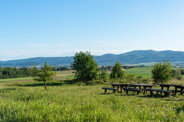 Wooden picnic tables with mountain views  