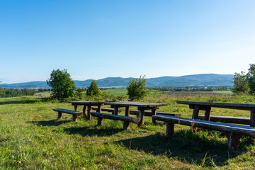 Wooden picnic tables with mountain views  