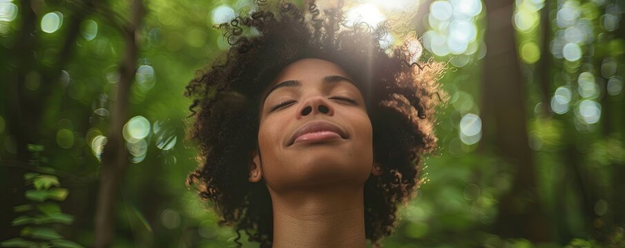 Young mixed race woman forest bathing with trees.