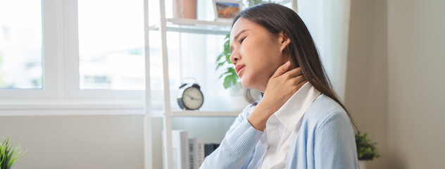Office workers have neck pain from bad posture during sitting and work.