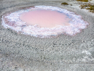 Subsidence funnels on salt marsh are filled with lakes of diverse colors. Red color caused by...